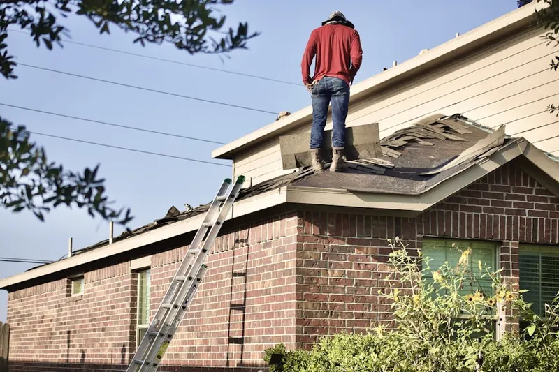 Professional roofer working on a residential roof in Bent Pine
